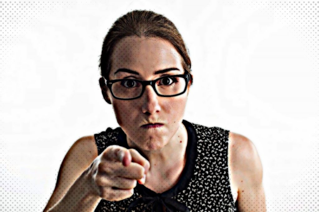 Mean looking woman pointing finger at someone